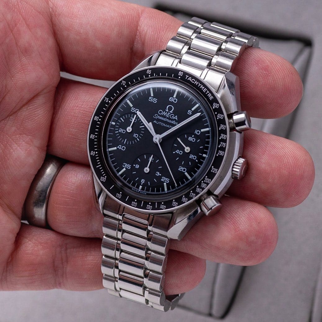 Black dial with 5-minute-increment labels next to the printed white indices. White hands. Omega Speedmaster Reduced ST 175.0032
