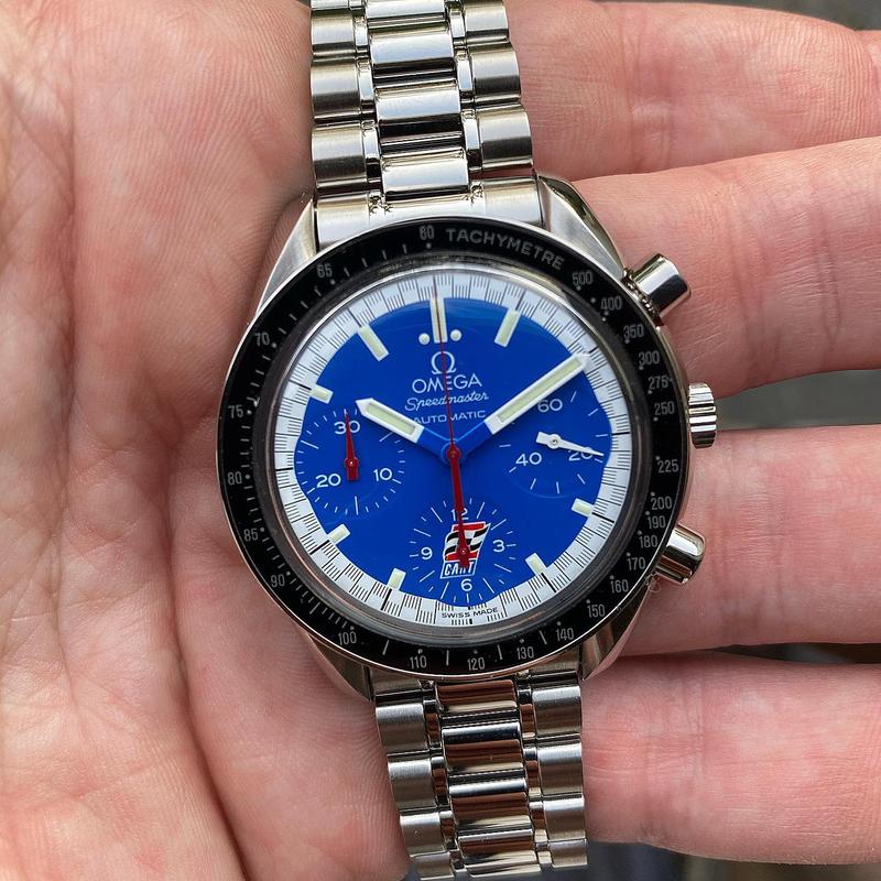 Schumacher blue dial with “Cart” logo in 12-hour-display. Outer ring along the seconds track in a black-and-white “racing” pattern. Chronograph hands in red. Hour, minute and seconds hand in white. Omega Speedmaster Reduced 3510.80.00