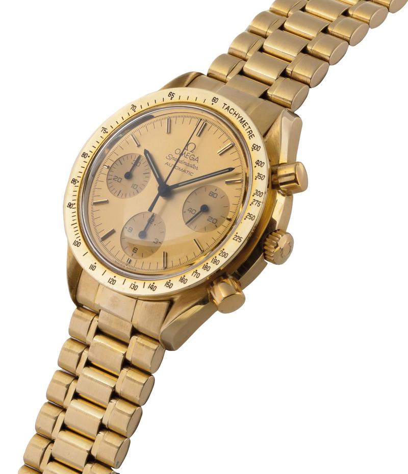 Golden dial with golden bezel and gold case. One of the few Speedmaster Reduced models with a transparent caseback showing the movement. Golden applied indices with a black contrast line. Black hands. Omega Speedmaster Reduced BA 175.0033
